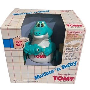 Vintage TOMY Pull String Motorized Toy
1989 Crocodile With Baby Teal and White
